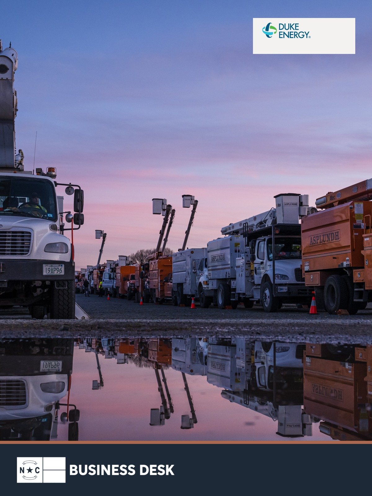 Duke Energy utility bucket trucks at a storm base camp, with the official Duke Energy logo and NC Business Desk footer.