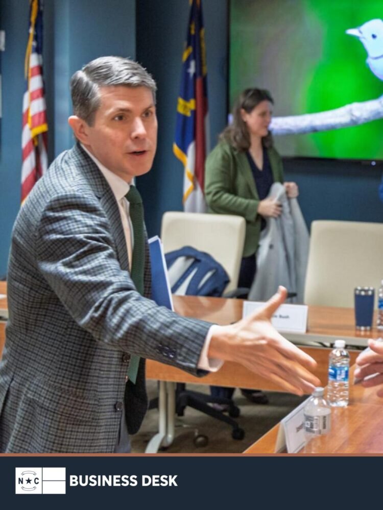 State Treasurer Brad Briner reaches to shake hands with a State Health Plan board member at the March 17, 2026, board meeting.