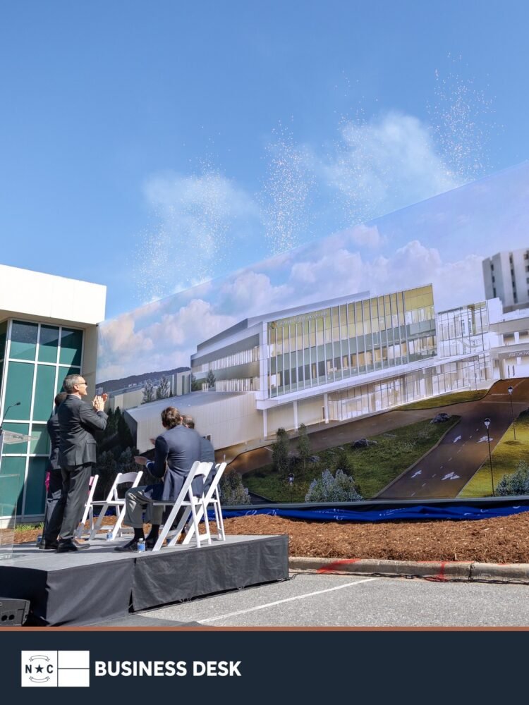 Attendees stand before a large rendering of the CaroMont Cancer Center during the May 15, 2026, construction kickoff in Gastonia.