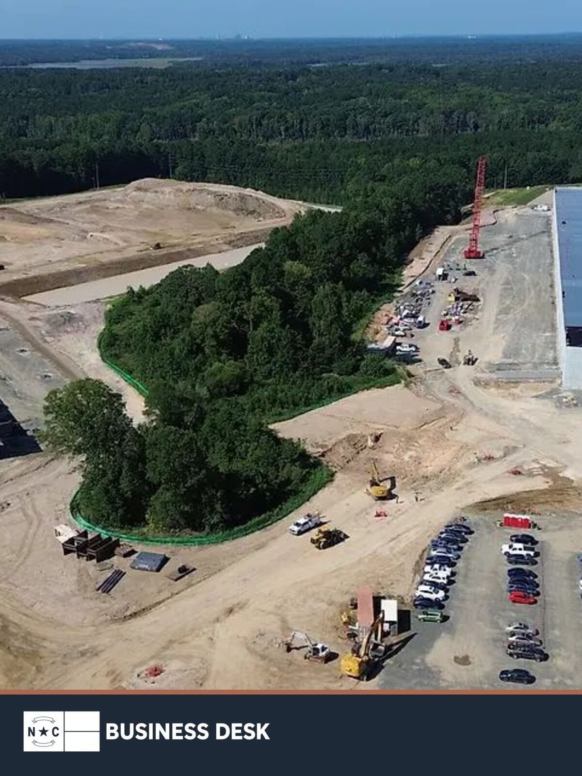 Aerial view of construction at Falls Lake Industrial Park in Butner in September 2026, above the NC Business Desk footer.
