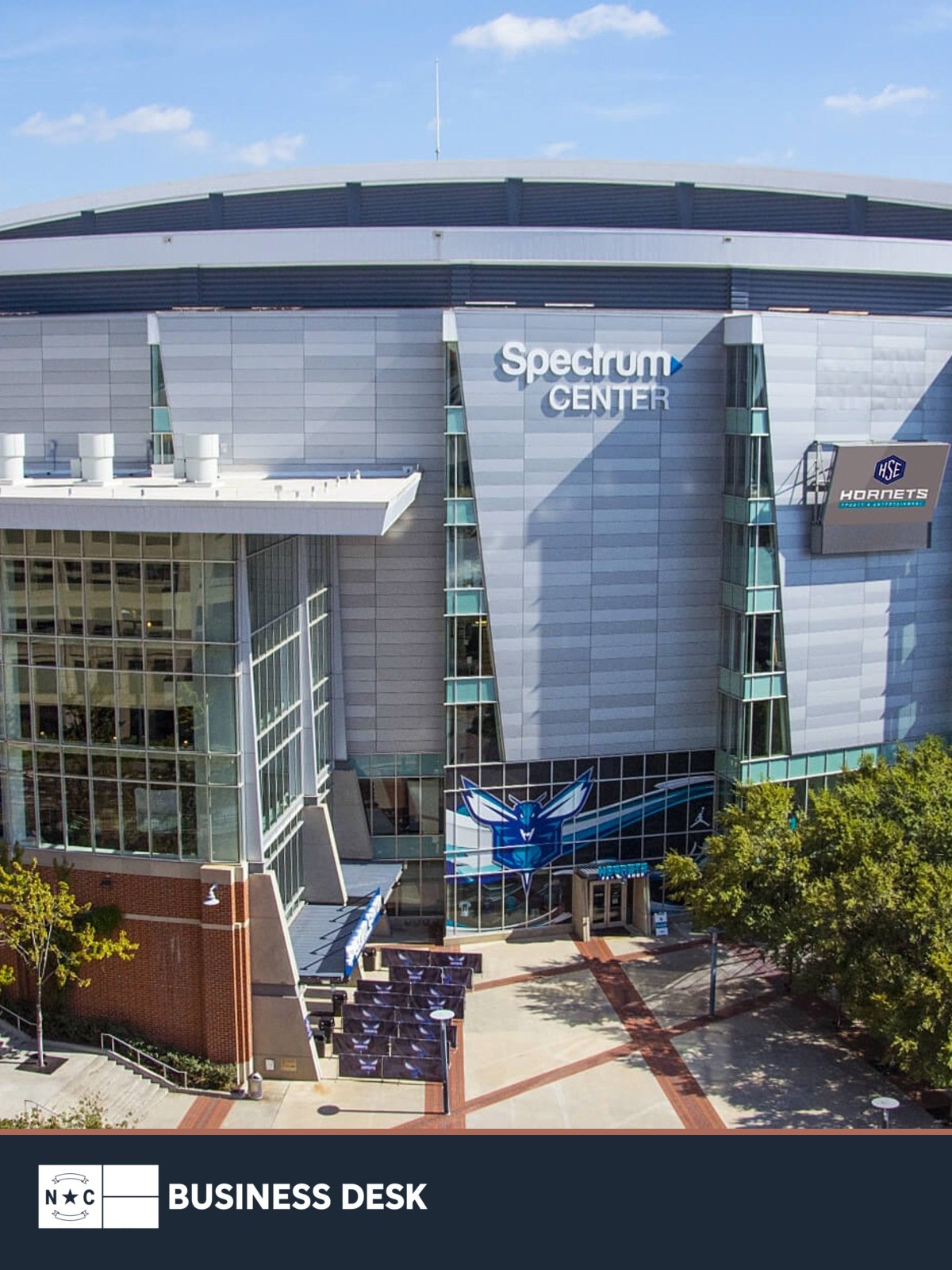 Official file photograph of Spectrum Center in Charlotte, venue for the 2027-2029 WTA Finals, above the NC Business Desk footer.