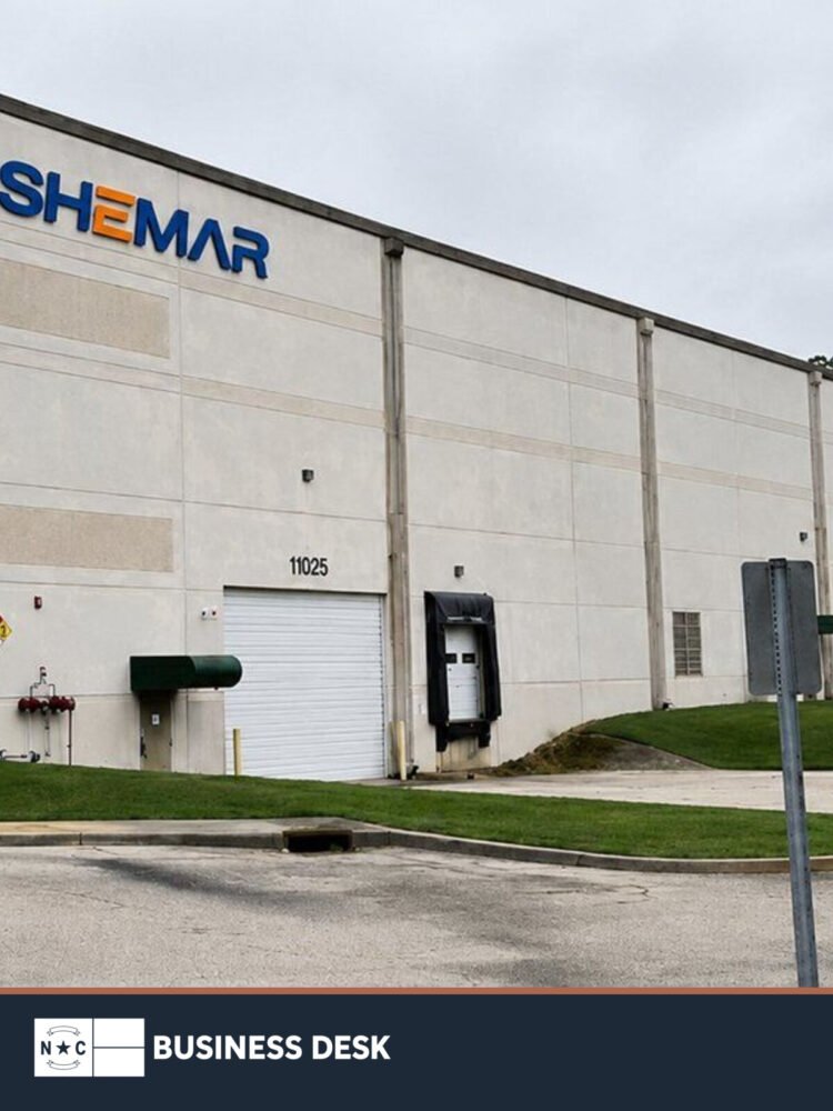 Company-supplied photograph of Shemar Electric USA signage on a north Charlotte industrial building above the NC Business Desk footer.