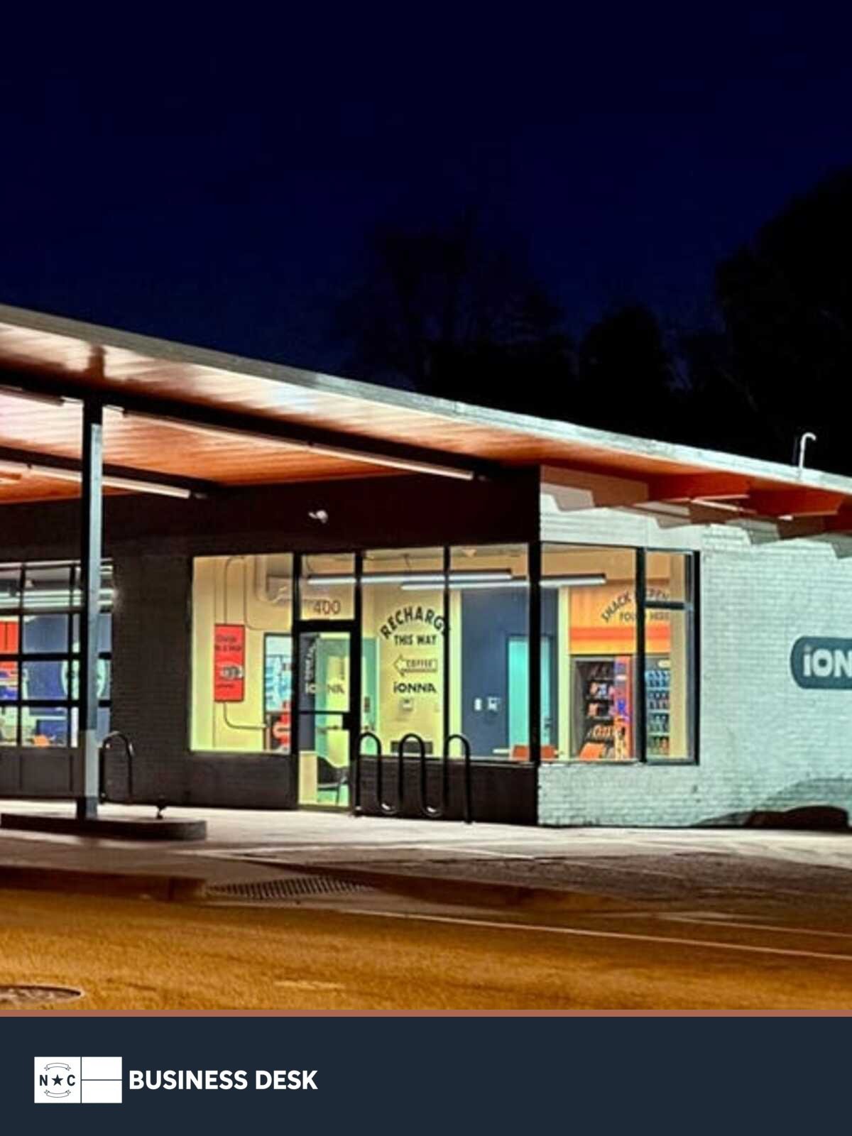 IONNA’s Apex, North Carolina, EV fast-charging station illuminated at night above the NC Business Desk footer.