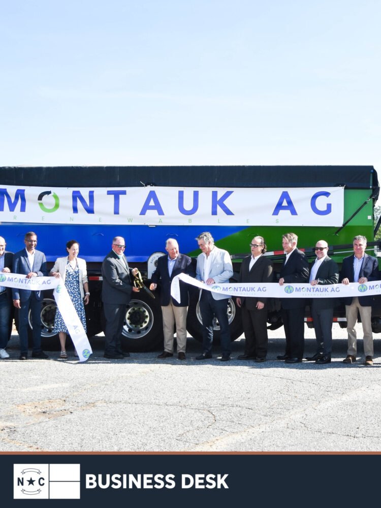 Montauk Renewables and Sampson County representatives hold a ribbon-cutting in front of a Montauk Ag truck at the Turkey facility.
