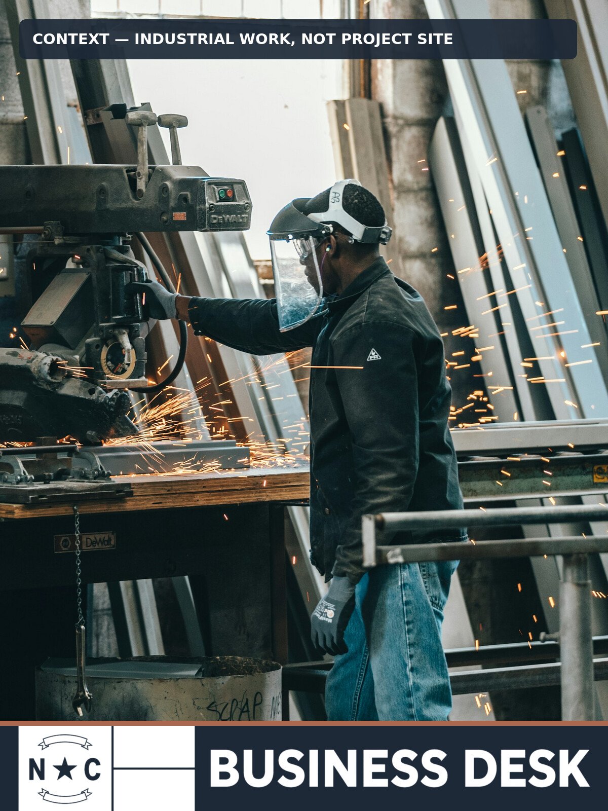 Worker operating industrial equipment in a workshop; contextual image, not Project Legacy or a disclosed Gaston County site