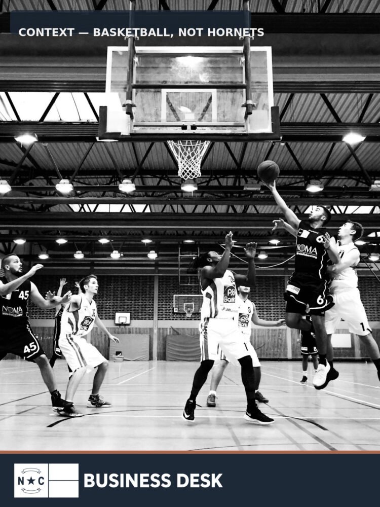 Basketball players competing in a gym; contextual image, not the Charlotte Hornets or Spectrum Center.