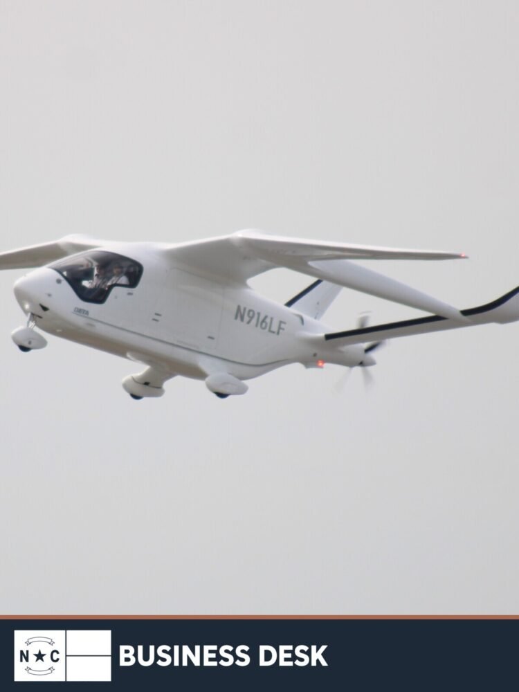 BETA Technologies ALIA CX300 electric aircraft in flight above Daytona Beach International Airport in a 2025 file photograph.