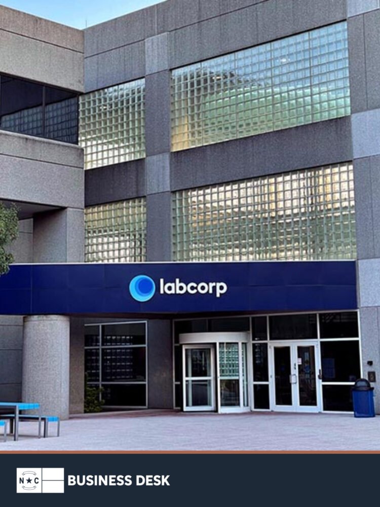Labcorp exterior with the company sign above the entrance, shown above the NC Business Desk footer.