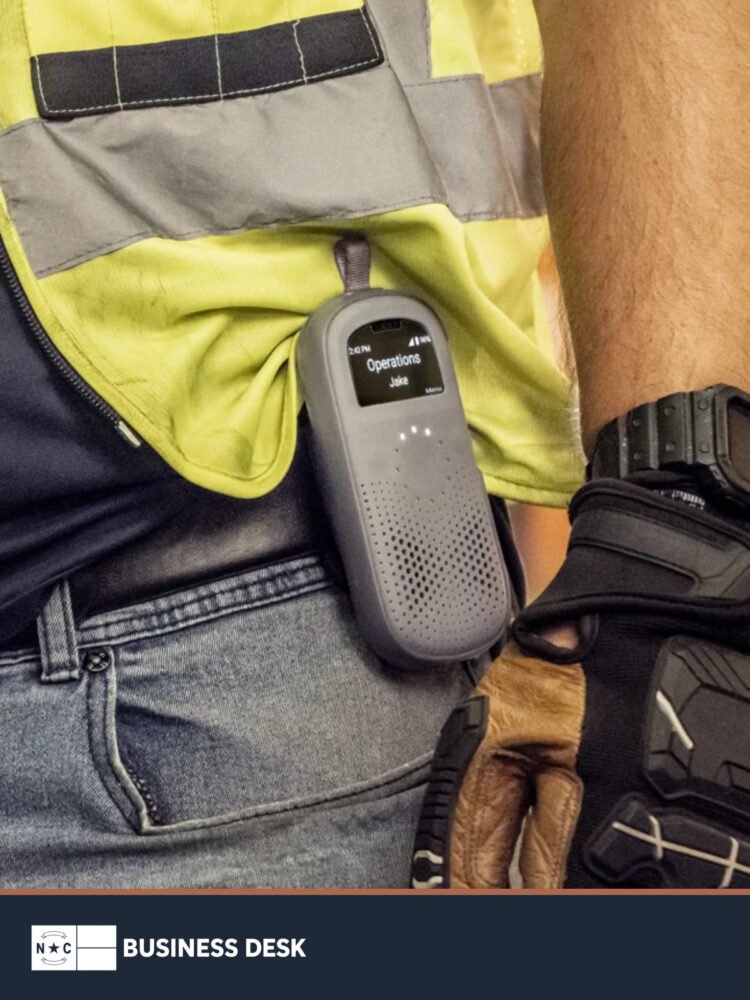 Frontline worker wearing a Relay smart radio above the NC Business Desk footer.