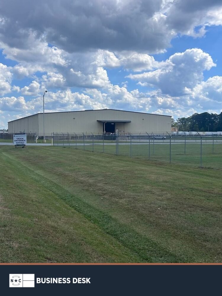 MasterBrand Cabinets manufacturing facility in Kinston above the NC Business Desk footer.