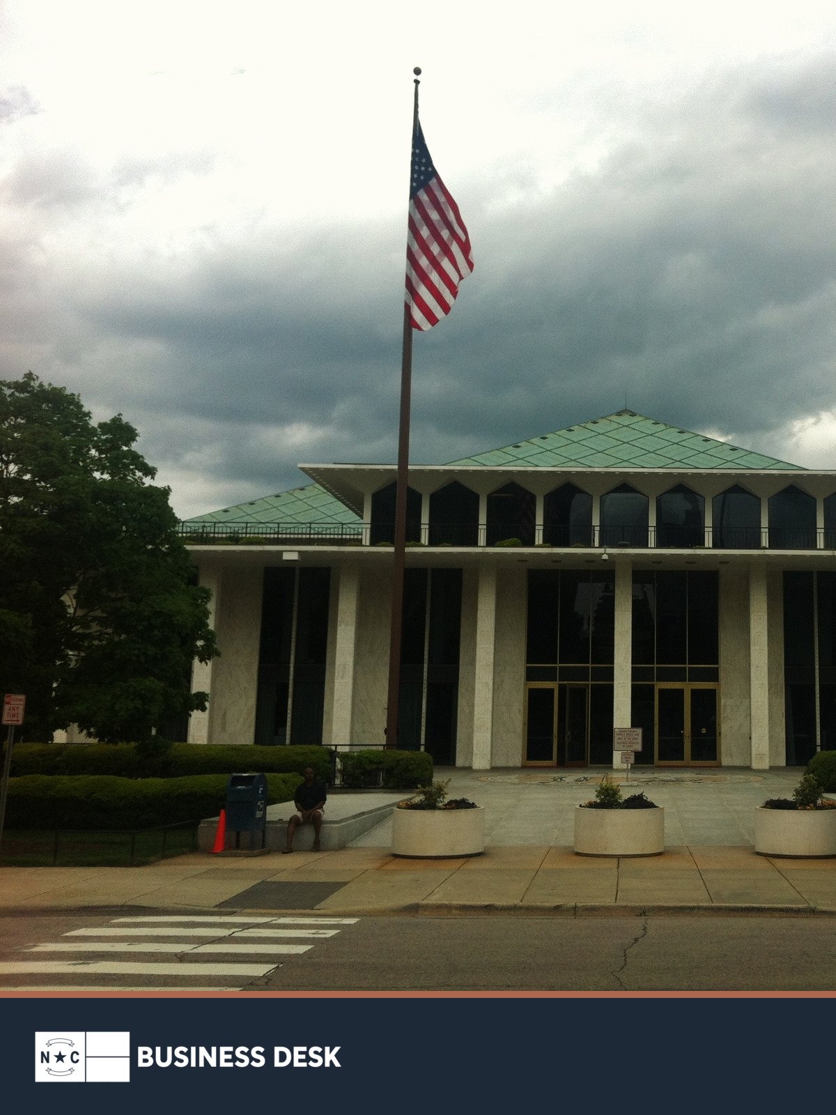 North Carolina Legislative Building in Raleigh with the U.S. flag above the NC Business Desk footer.