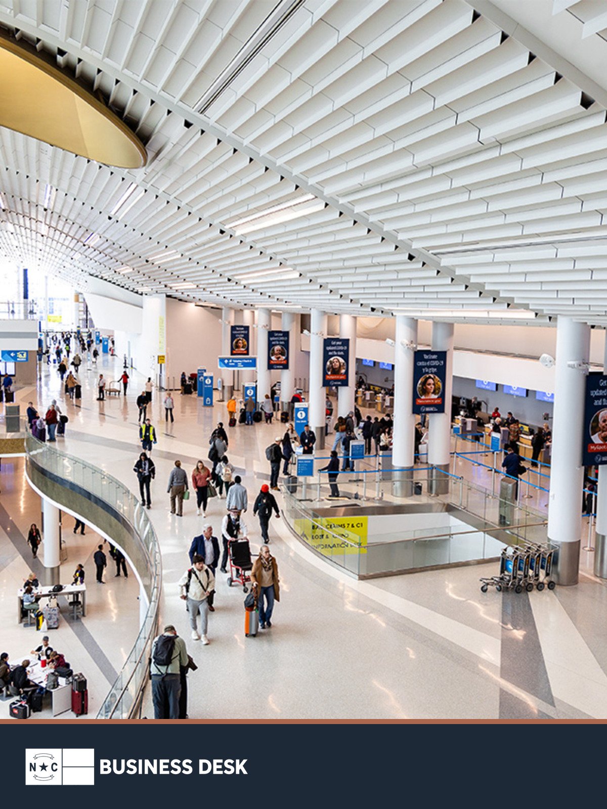 Charlotte Douglas International Airport’s existing terminal lobby above the NC Business Desk footer.