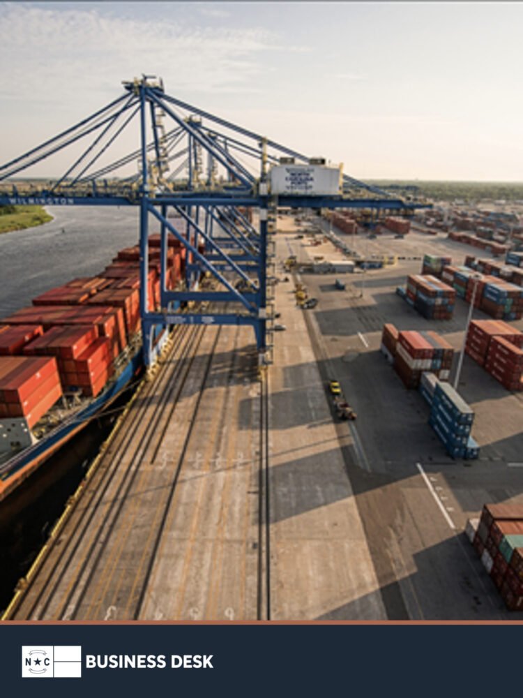 Aerial view of container cranes, a cargo ship and stacked containers at the Port of Wilmington.