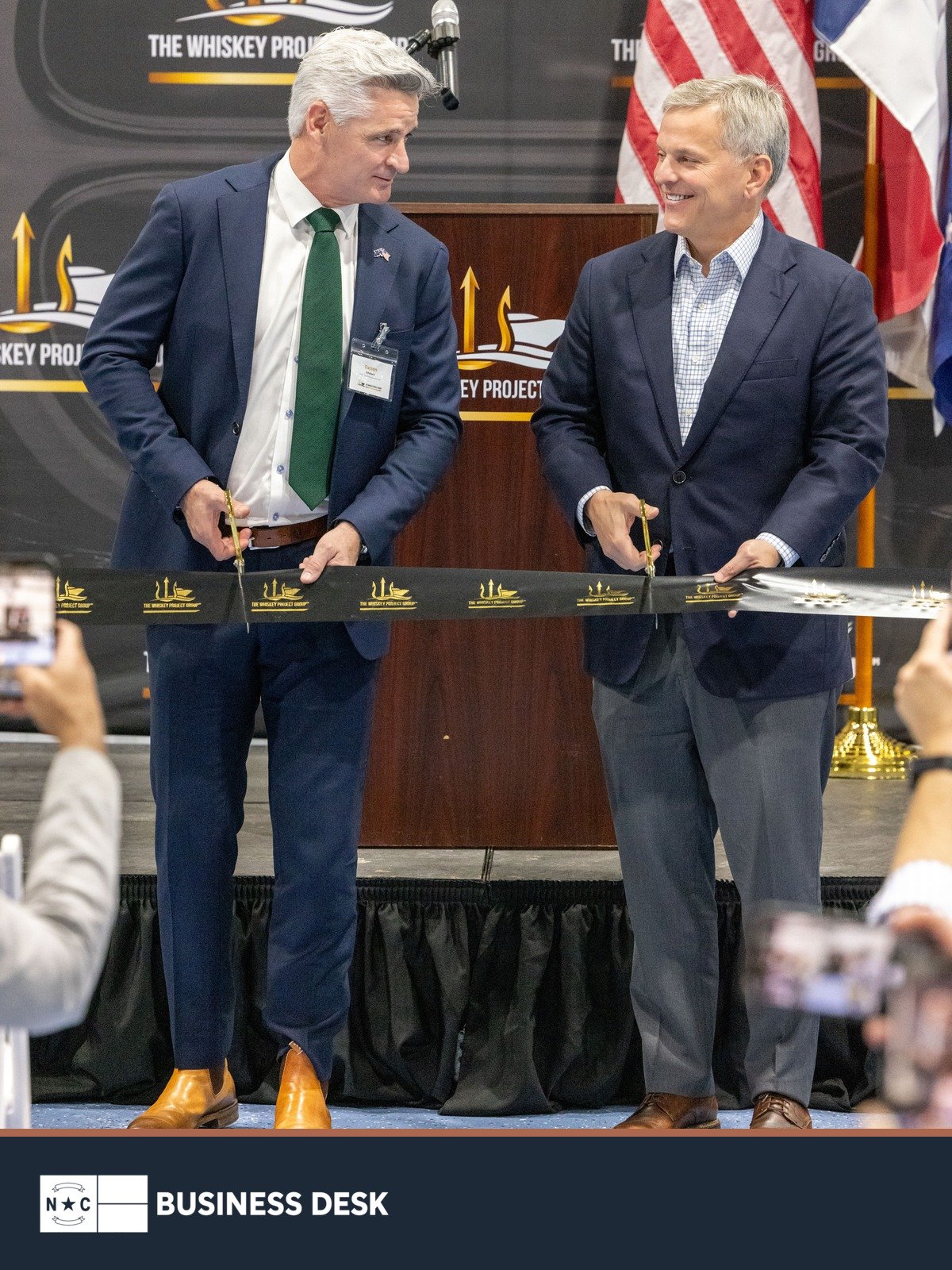 Gov. Josh Stein and Whiskey Project Group CEO Darren Schuback cut the ribbon at the company’s Edenton manufacturing hub above the NC Business Desk footer.