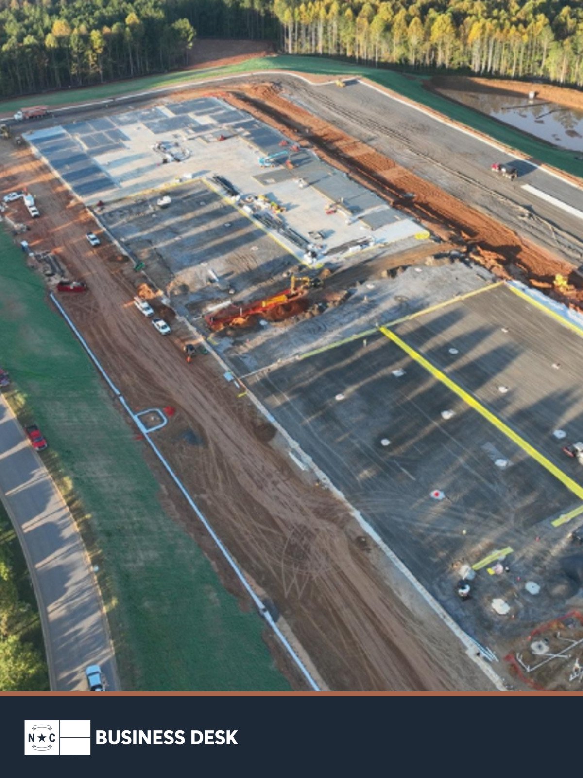 Aerial view of construction at the Catawba Commerce Center site tied to US Conec’s Hickory expansion, above the NC Business Desk footer.